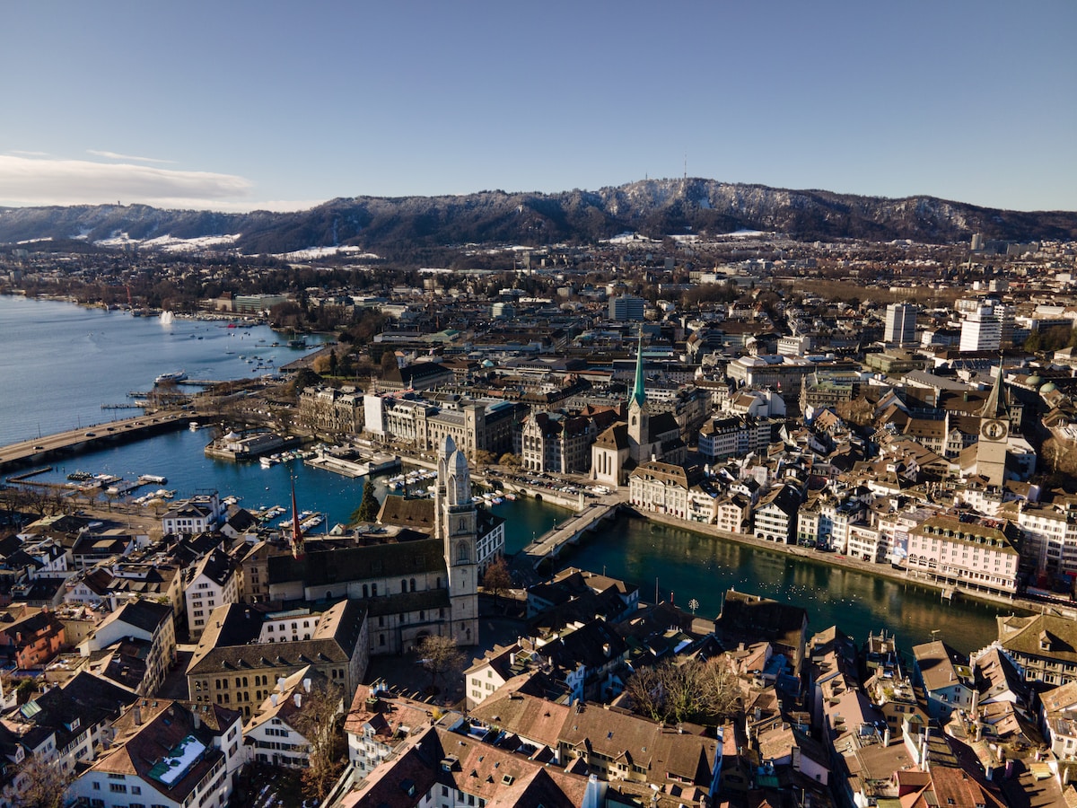 aerial view of city buildings near body of water during daytime Zürich Old Town
