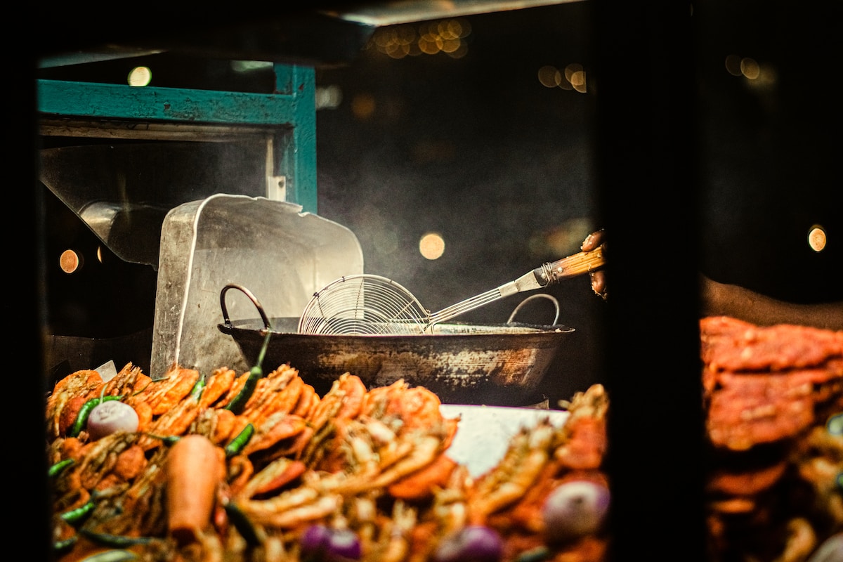 a pan of food is cooking on a grill - Galle Face Green