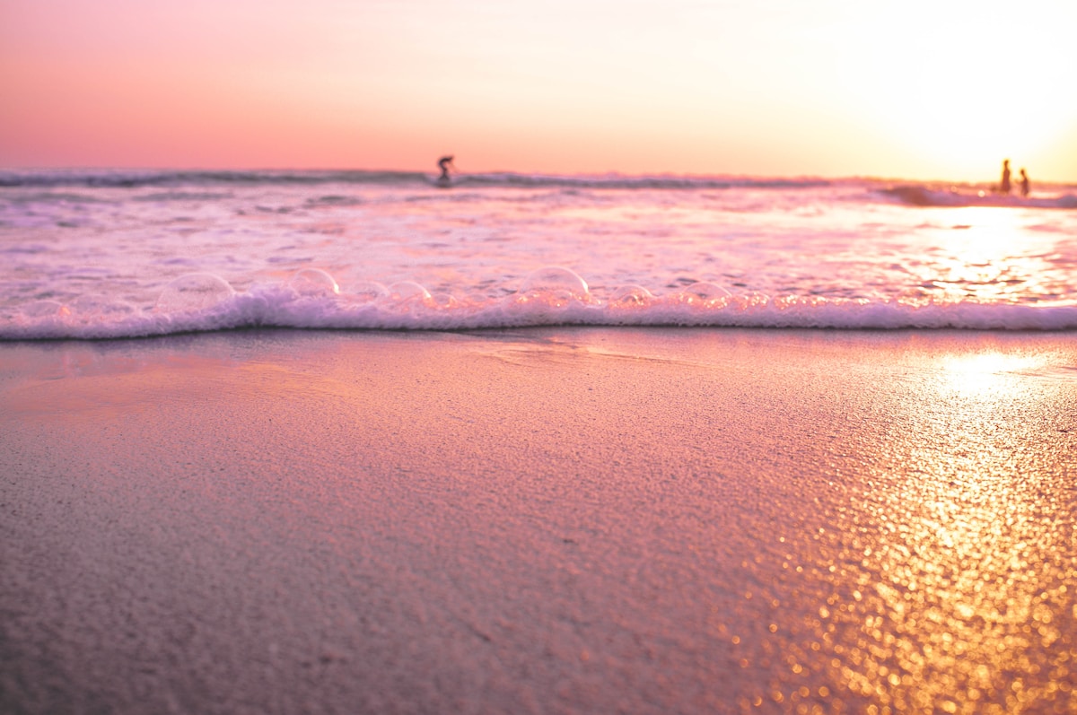 three persons in sea during golden hour - Seminyak Bali