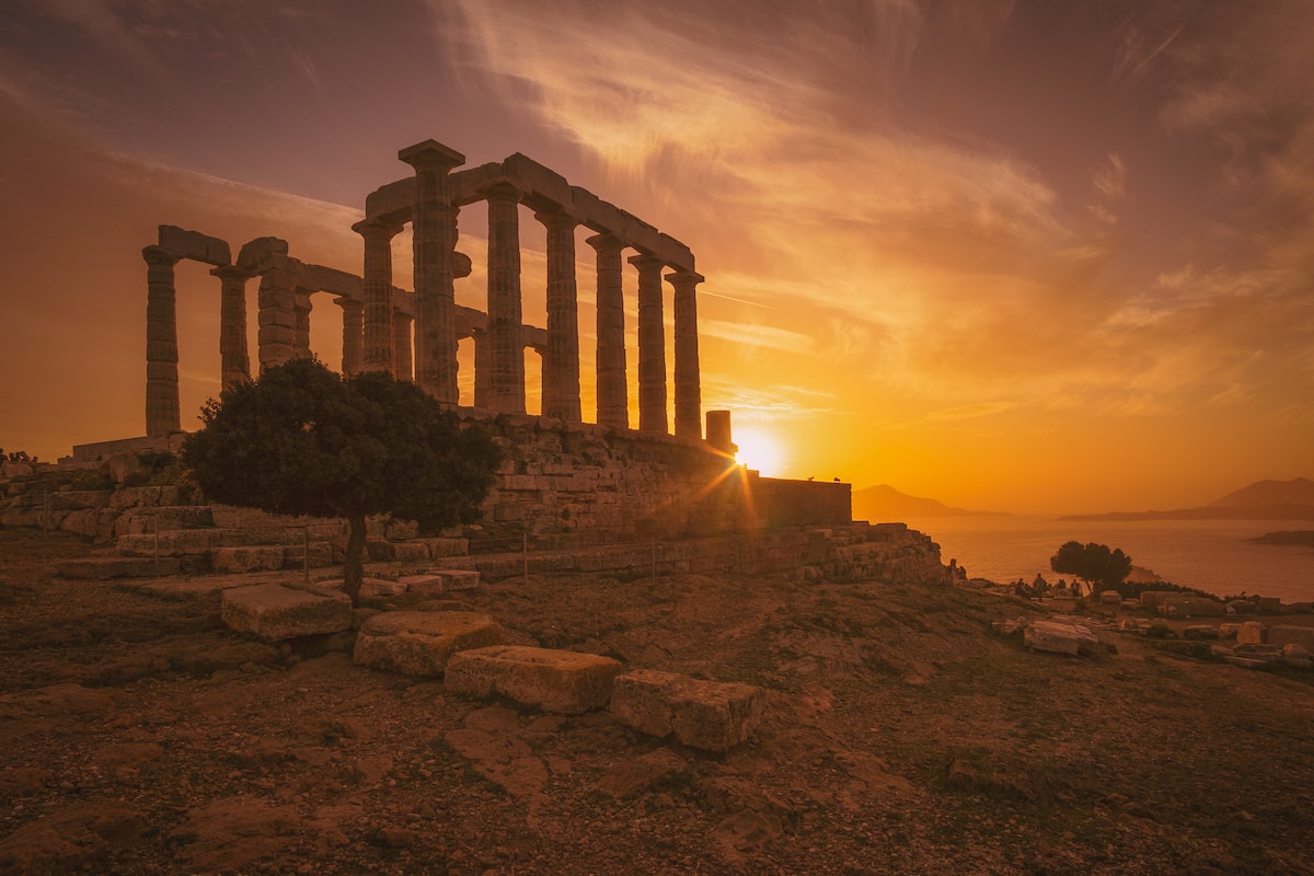 white concrete temple frame near body of water - Temple of Poseidon Athens, Greece