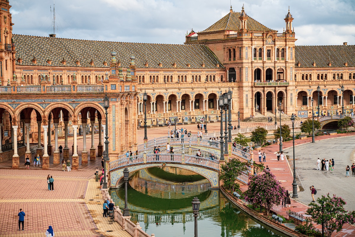 a large building with a bridge in front of it - Seville, Spain