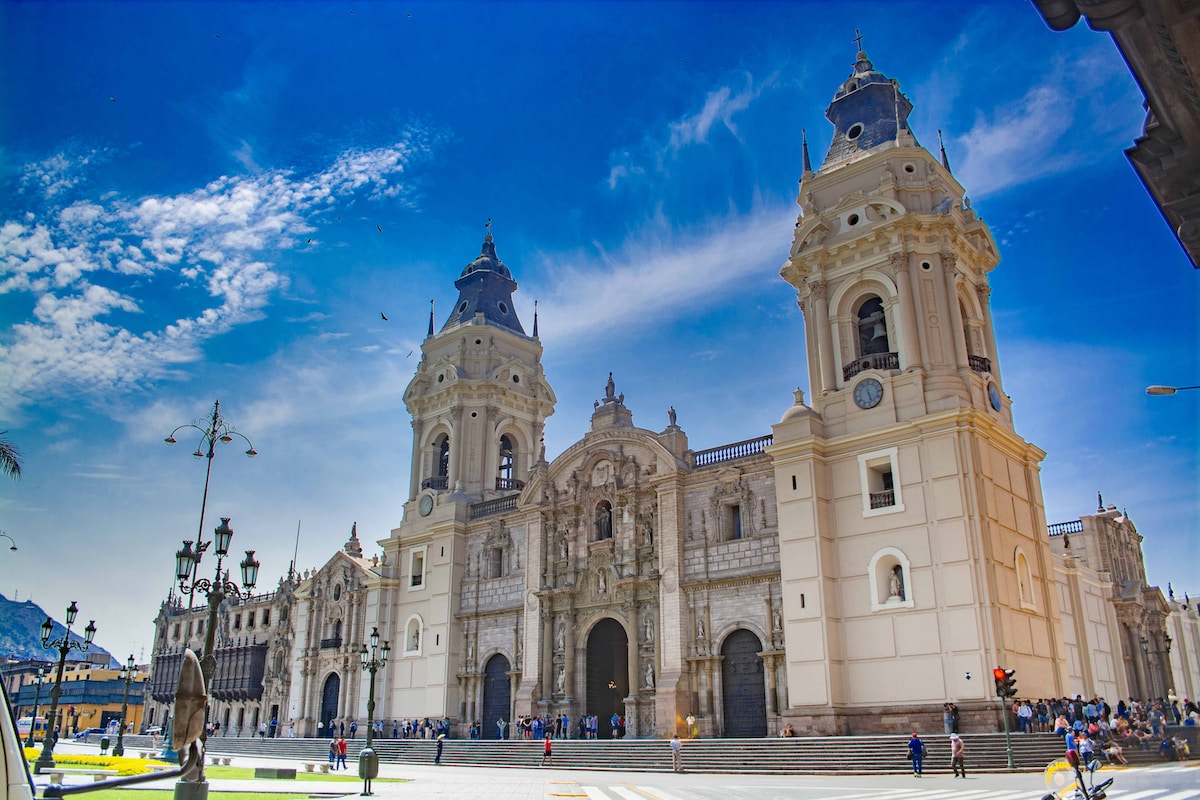 Lima, Peru - beige concrete building under blue sky and white clouds during daytime