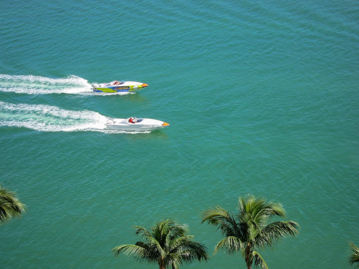 Two single engine speed boats cruising along bay - Miami, Florida, USA