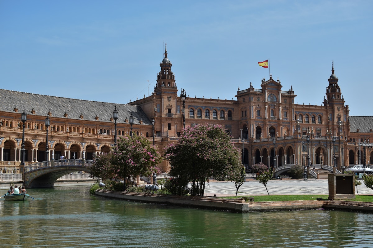 a large building sitting next to a body of water - Seville, Spain
