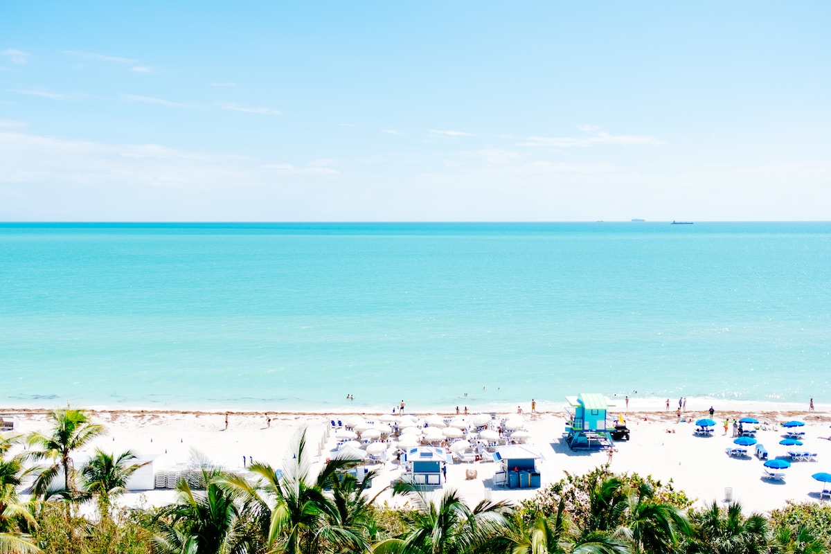 white sand beach with stalls under blue sky - Miami USA