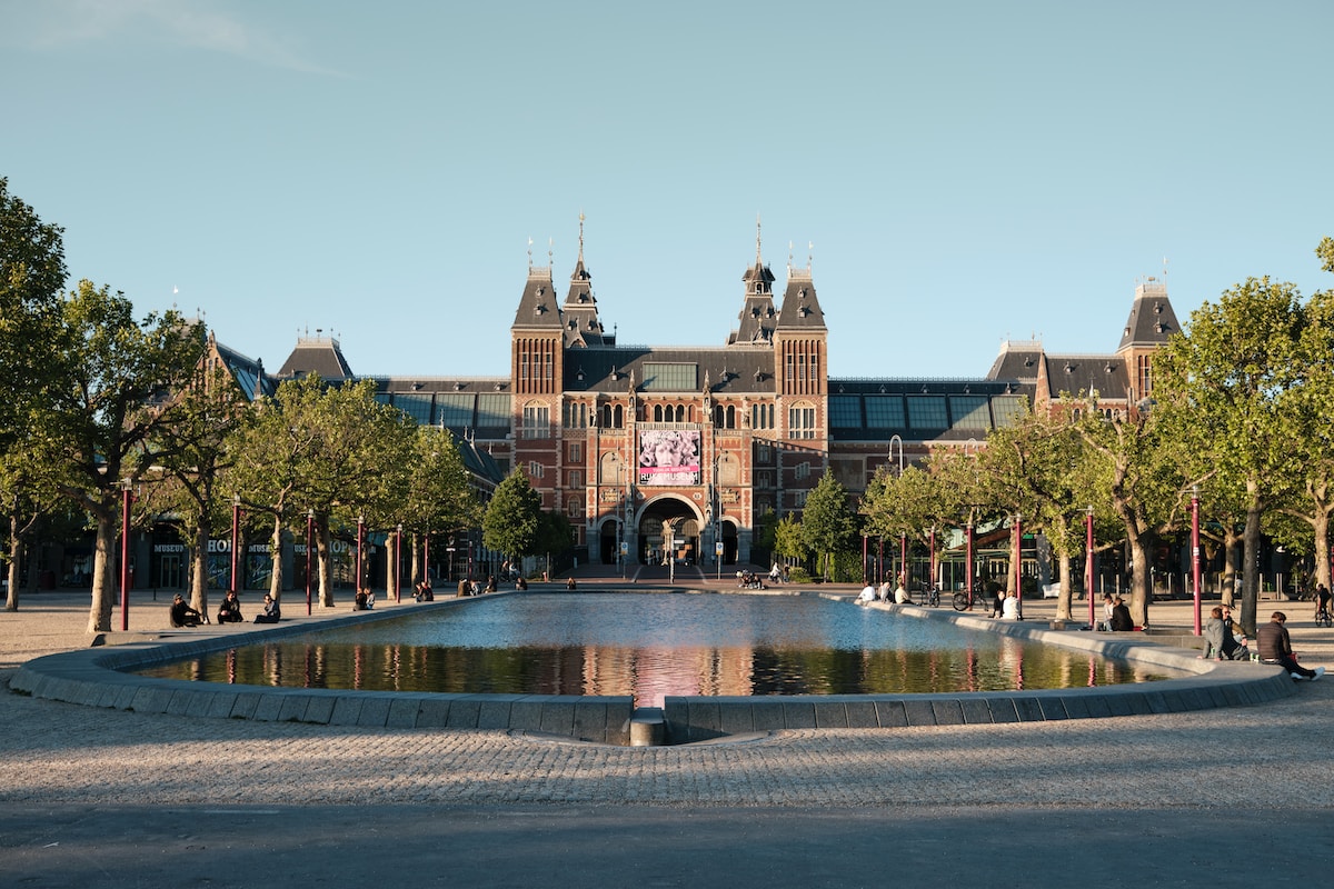people walking on park near brown building during daytime - Rijksmuseum