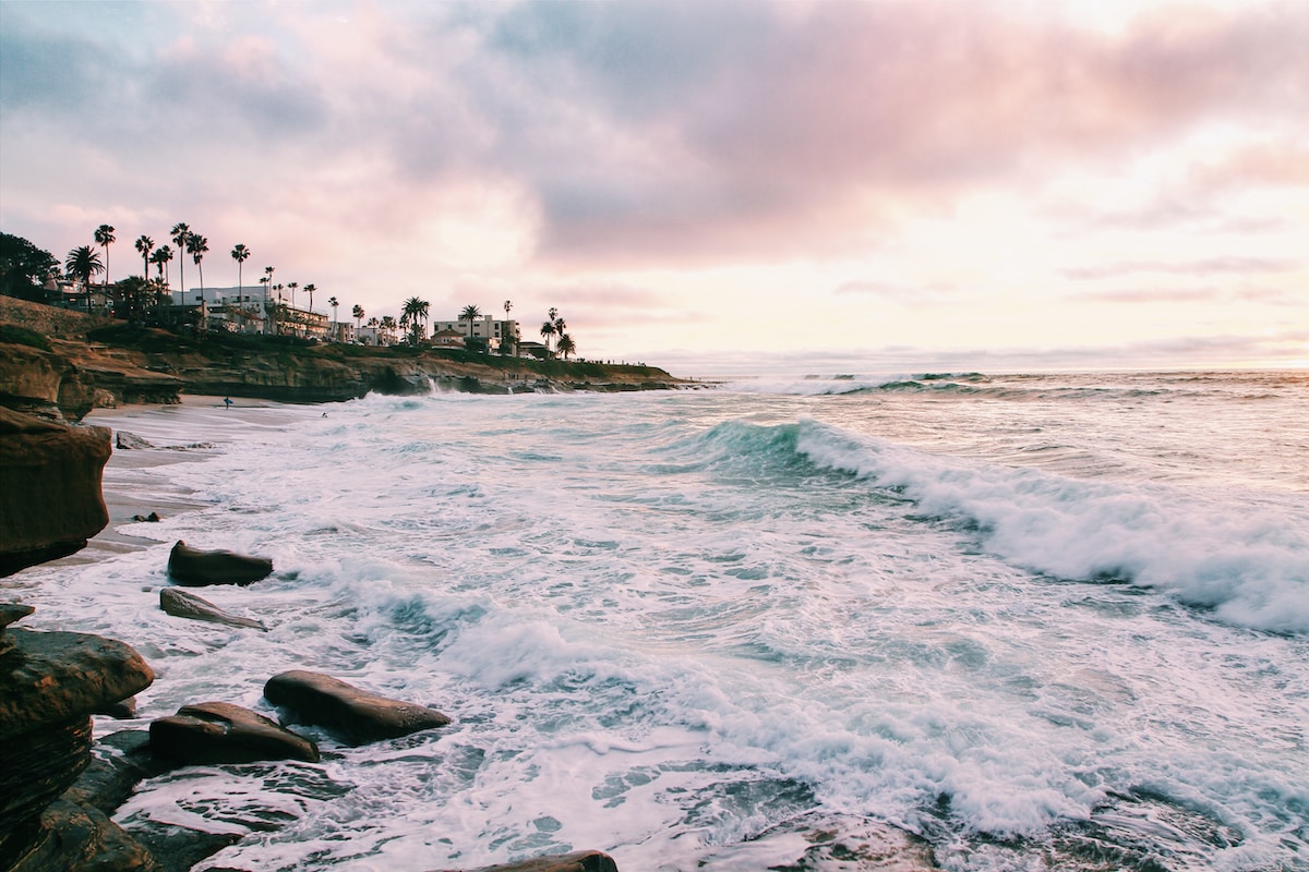 sea waves crashing on shore during golden hour - San Diego USA