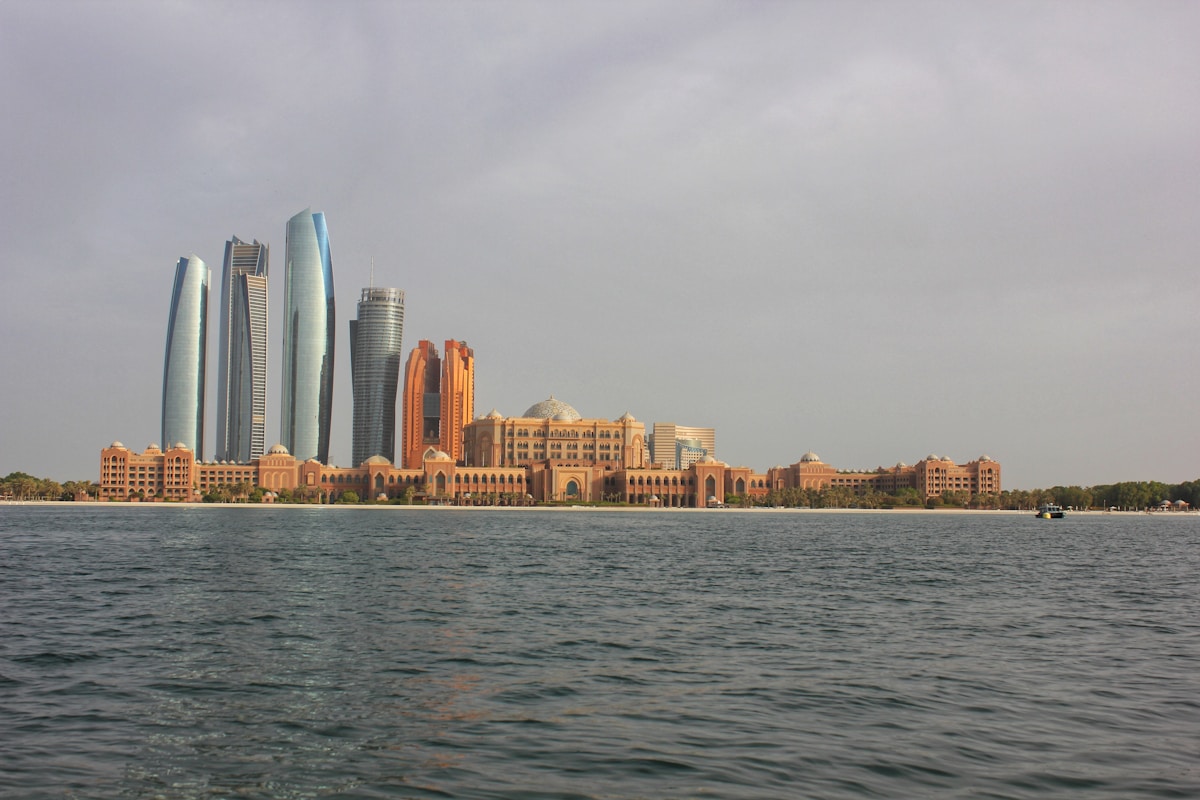 city skyline across body of water during daytime - Abu Dhabi