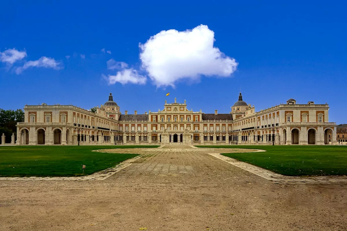 a large building with a long driveway in front of it - Palacio Real, Madrid, Spain