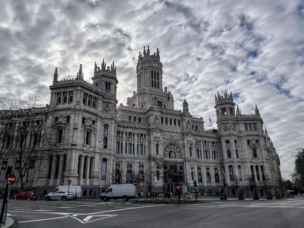 a large building with a clock tower on top of it - Plaza de Cibeles, Madrid, Spain