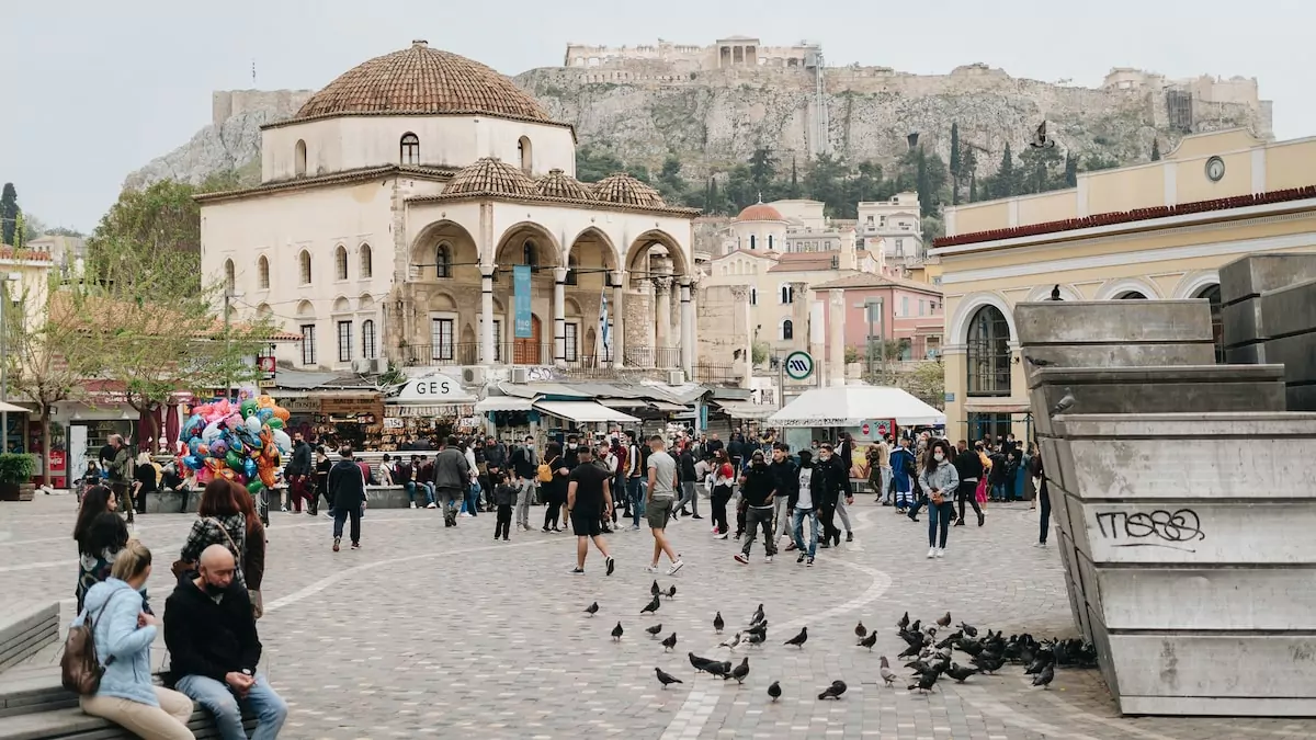 a group of people walking in front of a building Shopping in Athens