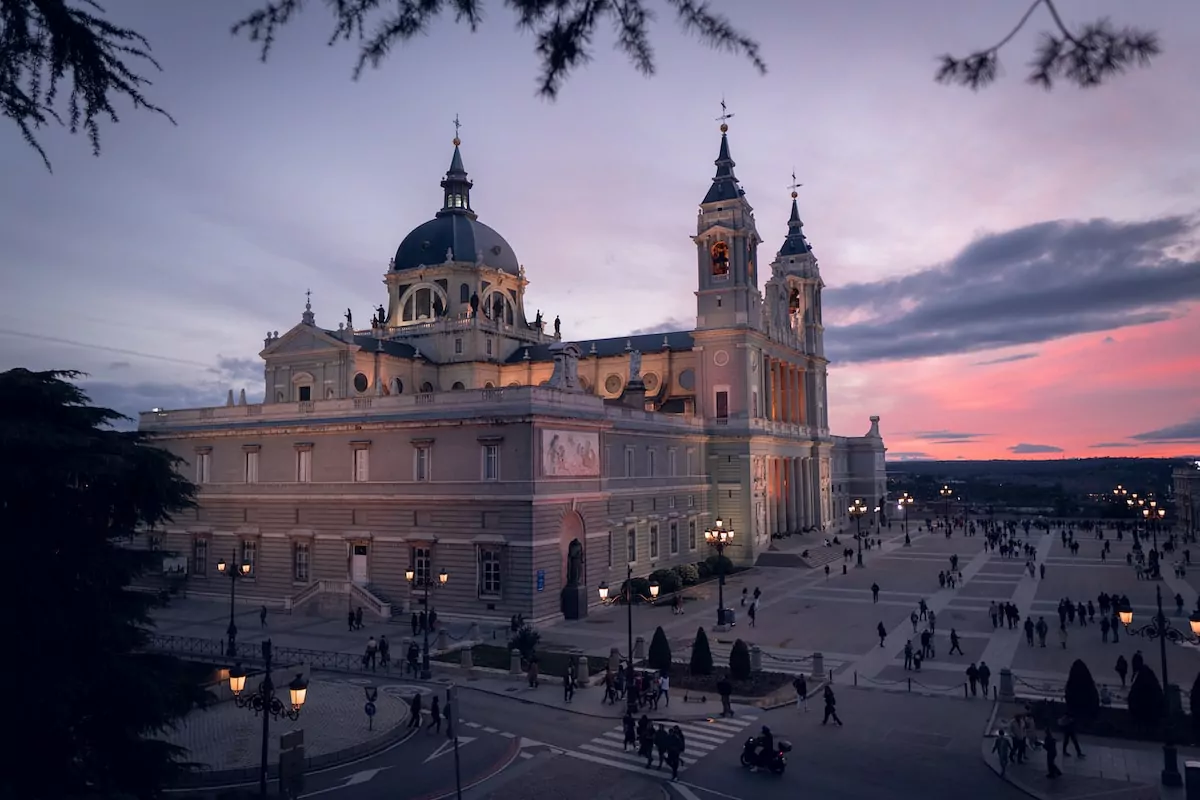 a large building with a clock tower at dusk - Madrid, Spain