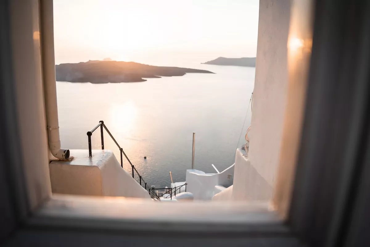 a window view of a body of water - Fira Santorini