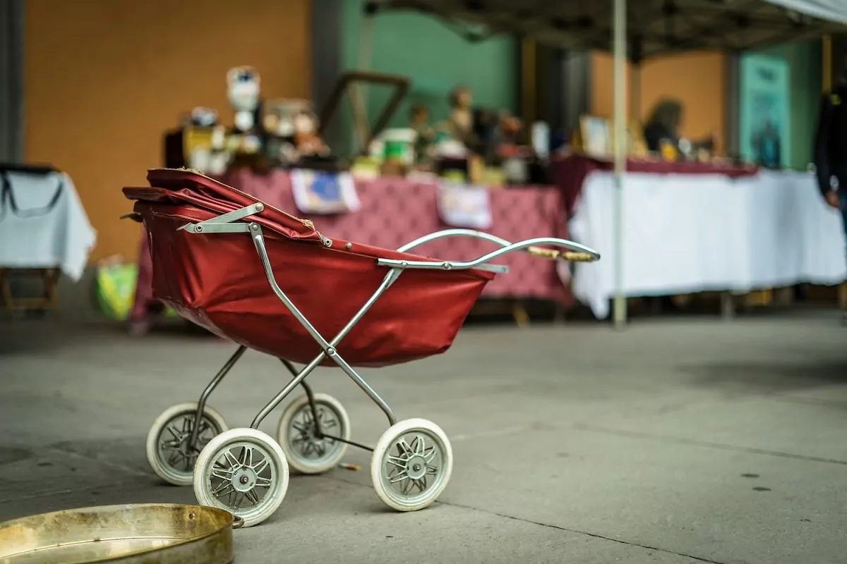 selective focus photography of red bassinet stroller - Flea markets