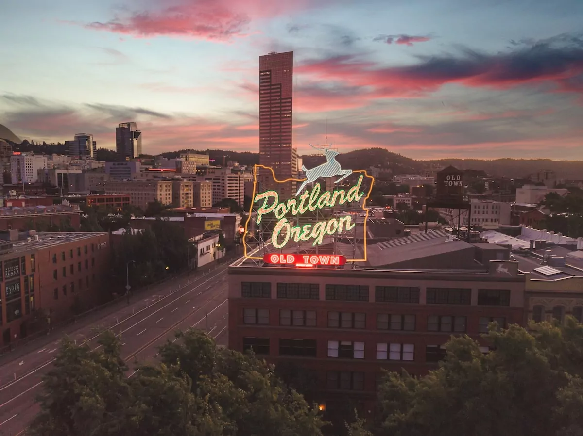 a large neon sign on top of a building - Portland USA