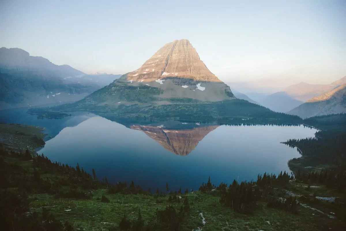 aerial view of lake near mountains - Glacier National Park USA