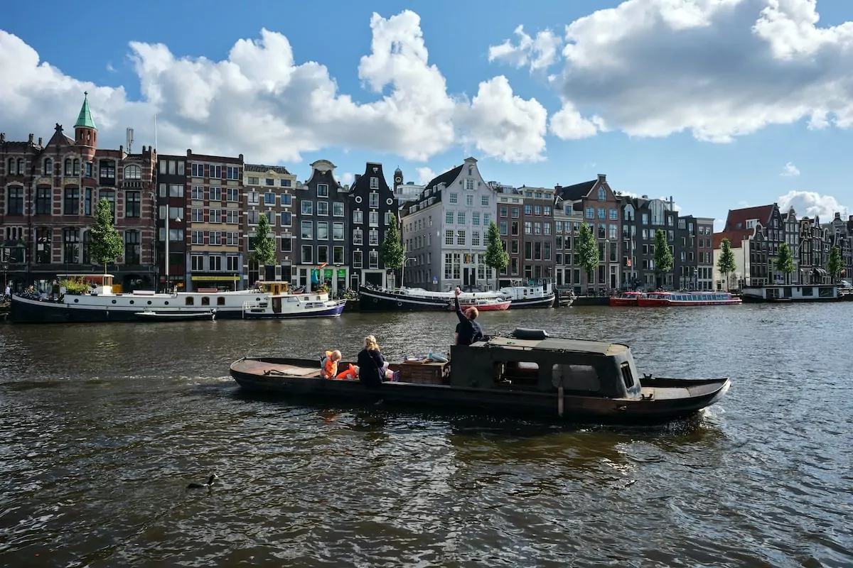 people riding on boat on river during daytime - Amstel River Amsterdam