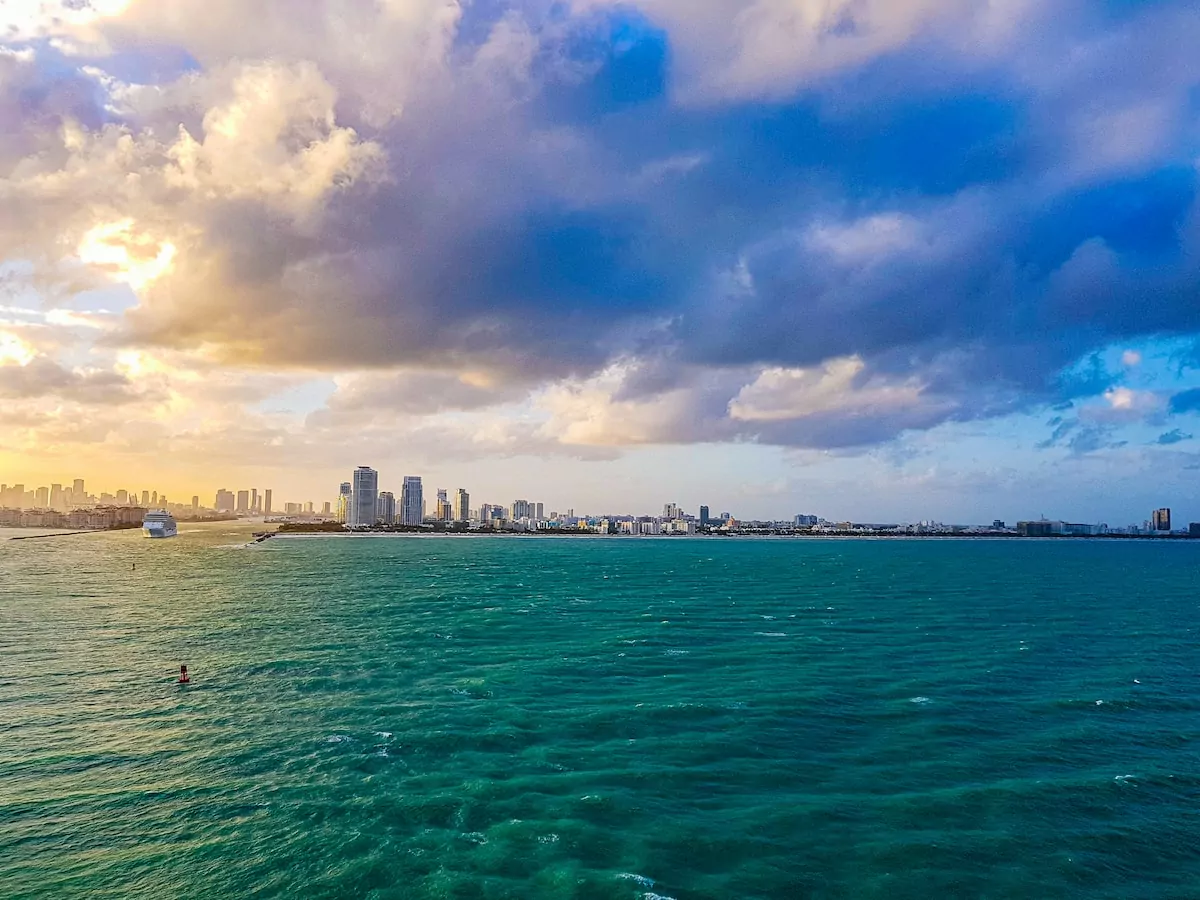Miami USA - city skyline across body of water under blue and white sunny cloudy sky during daytime
