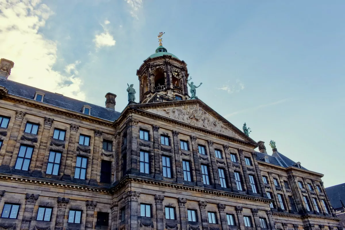 brown concrete building under blue sky during daytime - Royal Palace of Amsterdam
