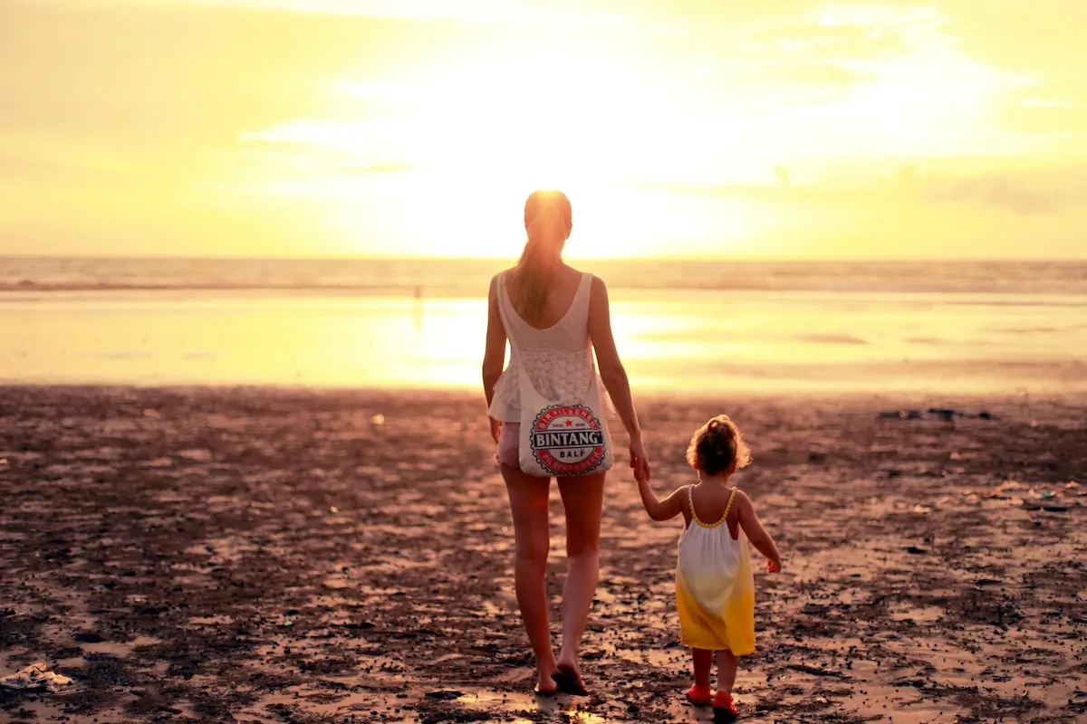 woman and child facing towards sunset - seminyak Bali