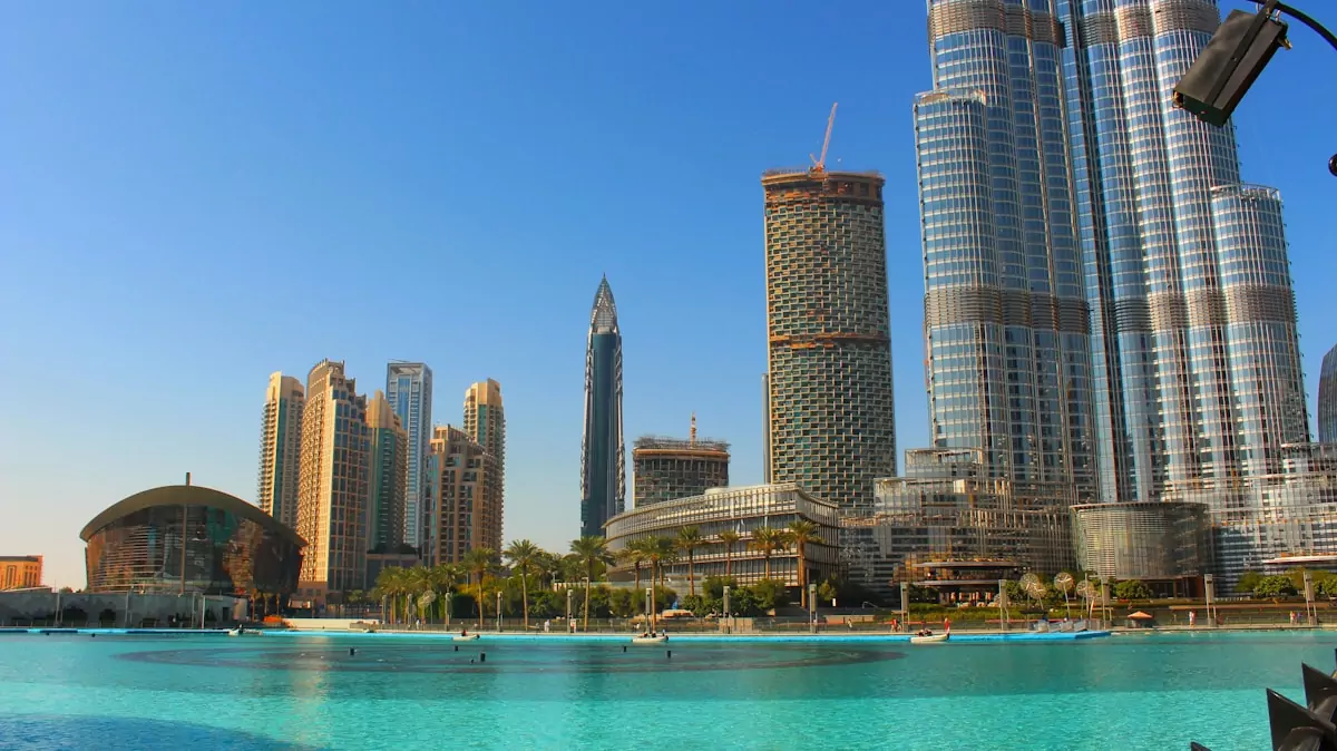 high rise buildings near body of water during daytime - Explore Abu Dhabi