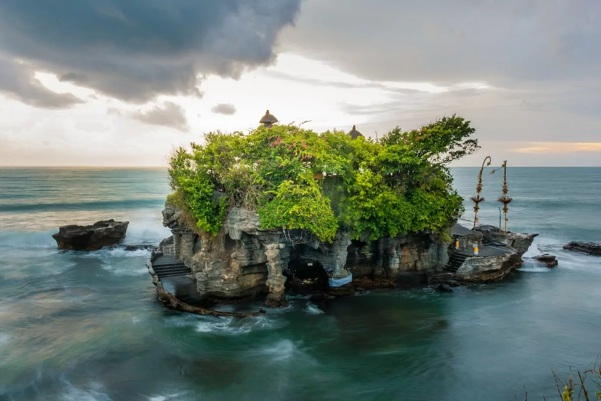 island surrounded with body of water - Pura Tanah Lot